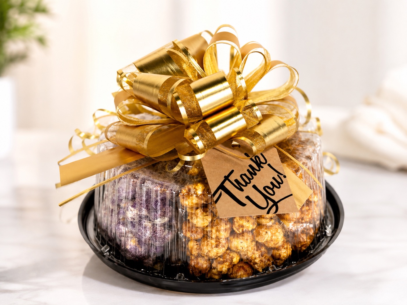 Ike's Gourmet Popcorn gift platter from Weslaco, TX, wrapped with a gold bow and a hand-written thank you tag